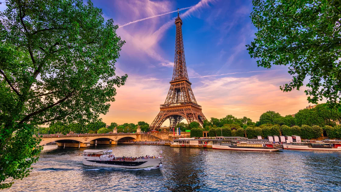The Eiffel Tower above the Seine at sunset