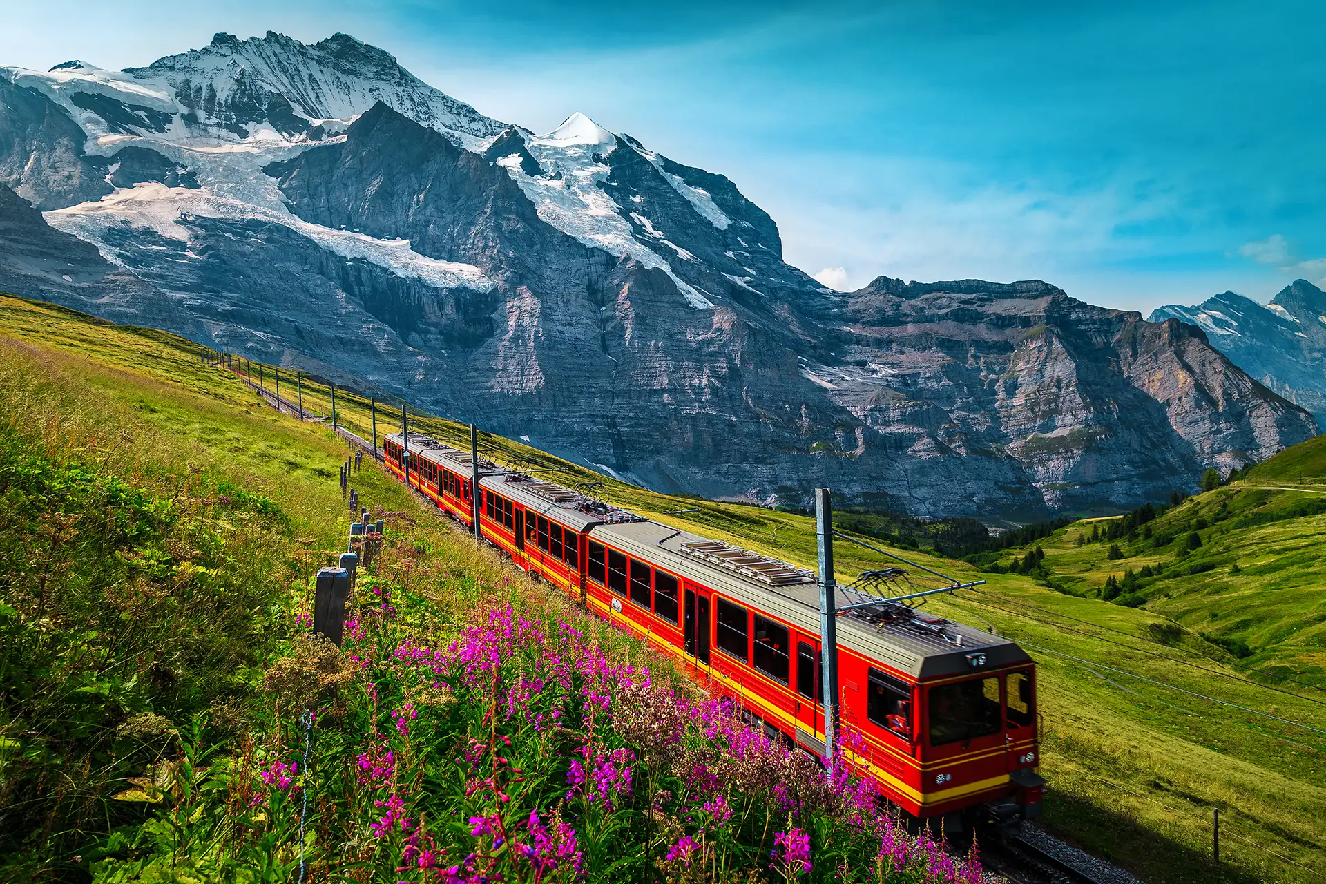 A panoramic red train crossing the Swiss Alps